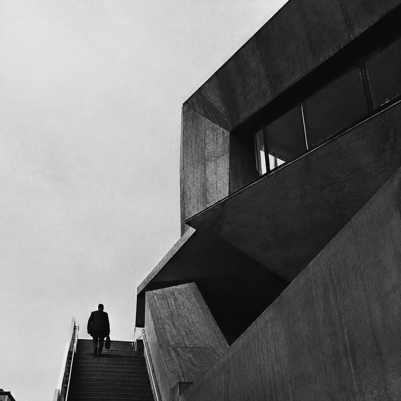 Concrete architecture with a person climbing stairs